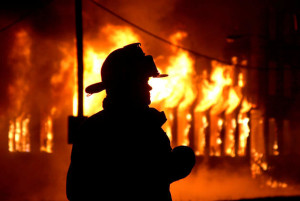 3july08 bishop--- FIRE--- An Elyria Firefighter siloueted by the flames of the former General Industries building.