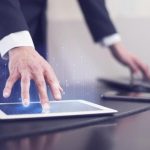 side-view-of-businessman-using-technology-on-tablet (1)