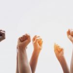 group-people-fists-raised-with-sunlight (2)