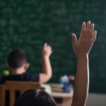 kid-raising-his-hand-in-classroom