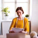 young-creative-woman-with-laptop-in-a-studio-a-sta-8QG5CDU.png