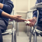 young-students-cheating-on-an-exam-P47M3T9 (1)