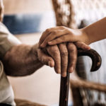 child-s-hand-over-old-man-s-hand-holding-a-cane-2 (1)