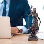 cropped-shot-of-lawyer-using-laptop-and-lady-justi-2021-08-30-01-27-15-utc (2) (1)
