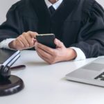 male-lawyer-or-judge-working-with-smart-phone-and-2021-09-04-14-49-53-utc (1)