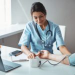charming-female-doctor-checking-patient-blood-pres-2021-09-04-14-23-32-utc