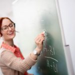 teacher-wearing-glasses-holding-chalk-while-writin-2021-09-03-20-25-41-utc (2)
